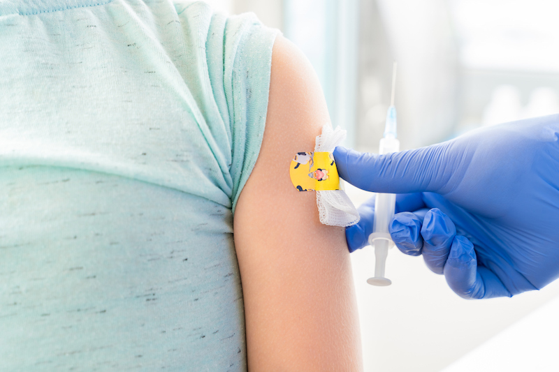 child getting a vaccine in pediatric clinic